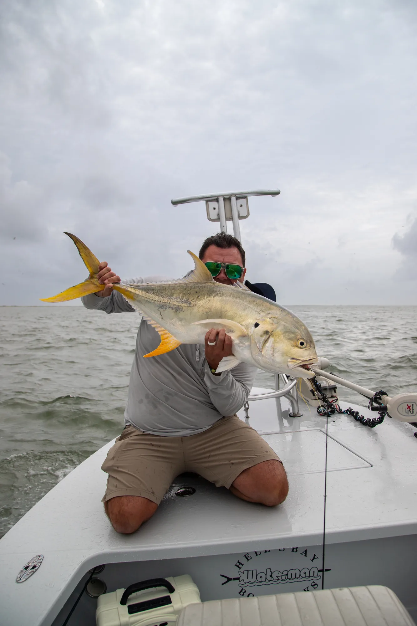Jack crevalle held boatside on a Hell's Bay Waterman skiff off Port O'Connor, Texas