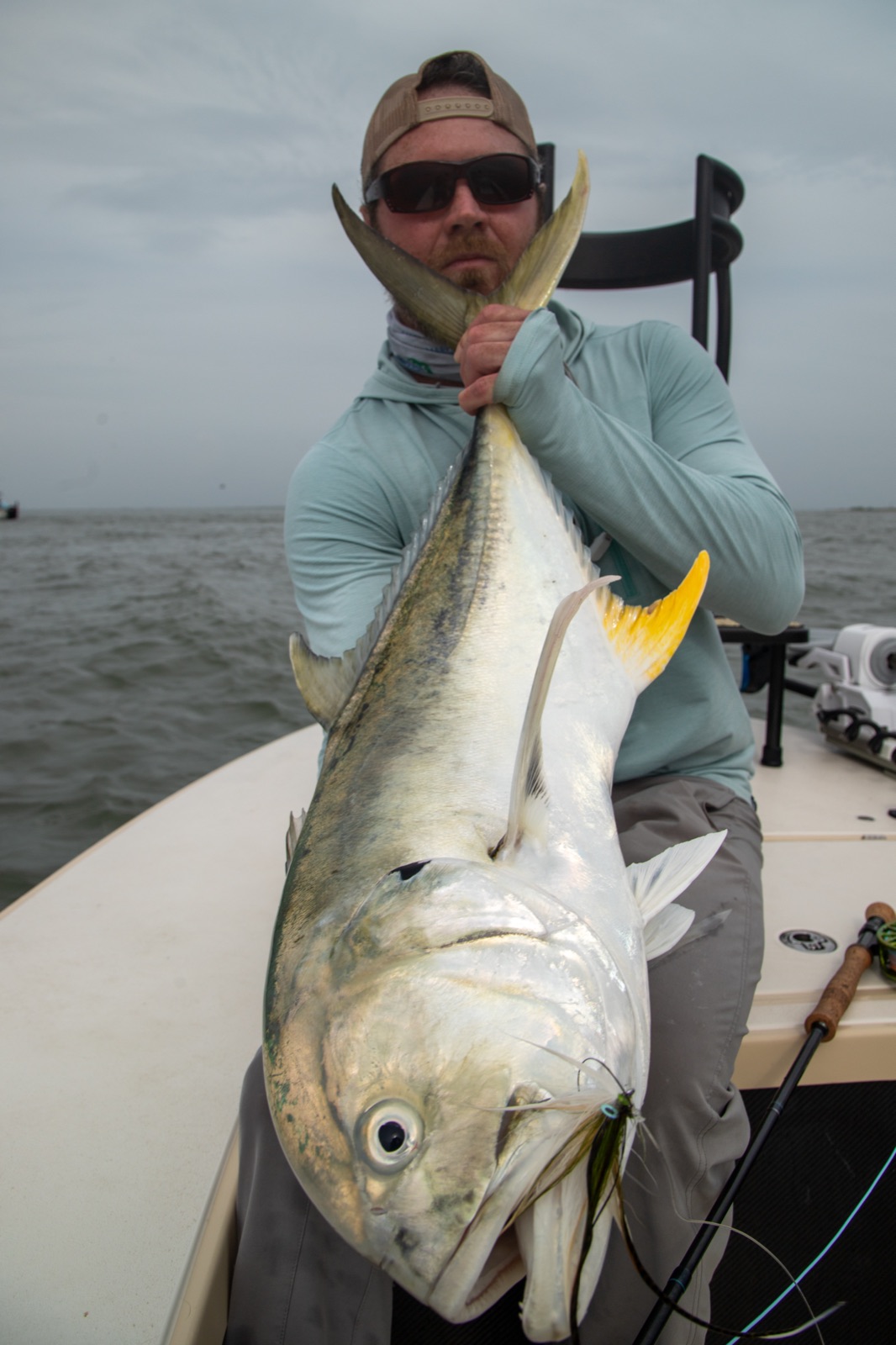 Angler holding a jack crevalle boatside on the Texas Gulf coast near Port O'Connor